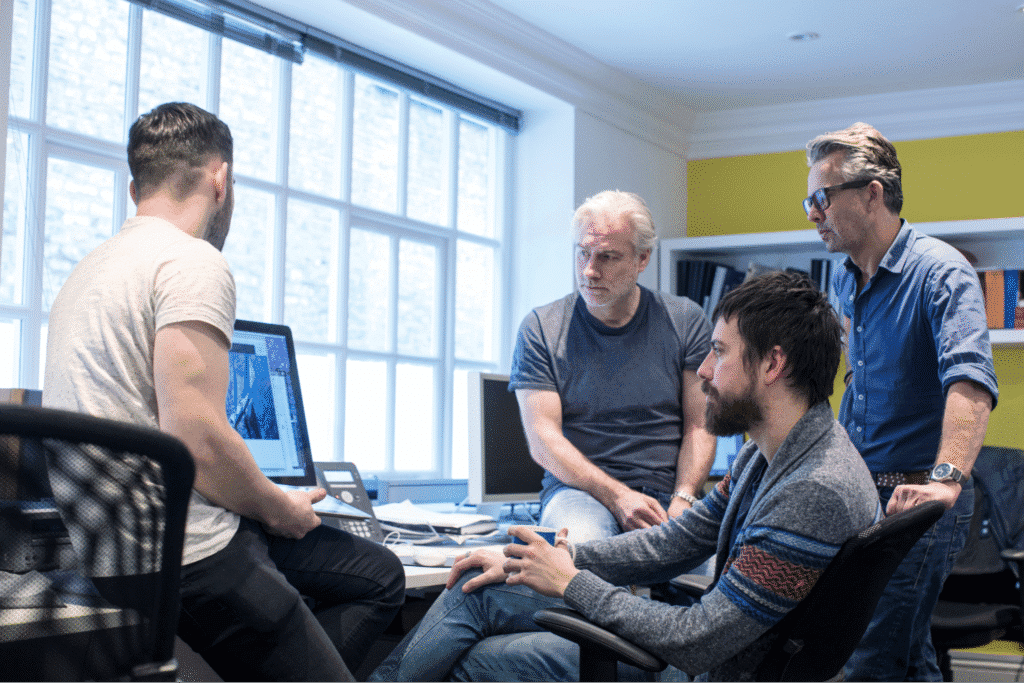 Team collaborating on project in a bright office setting.