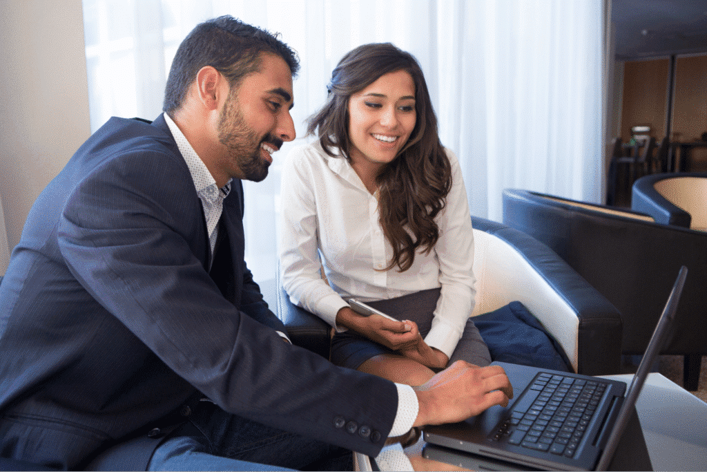 Colleagues collaborating effectively on a laptop in a stylish office environment.