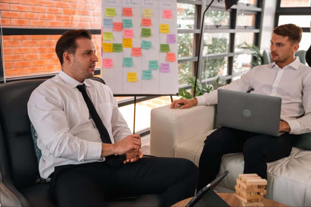 Professionals discussing strategies in a modern office setting with collaborative notes.