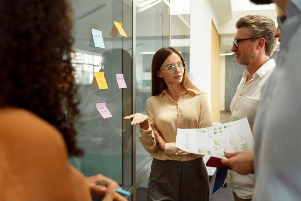 Team discussing ideas using visual aids and charts in a collaborative workspace.